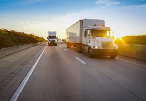 semi truck passing another semi truck on highway